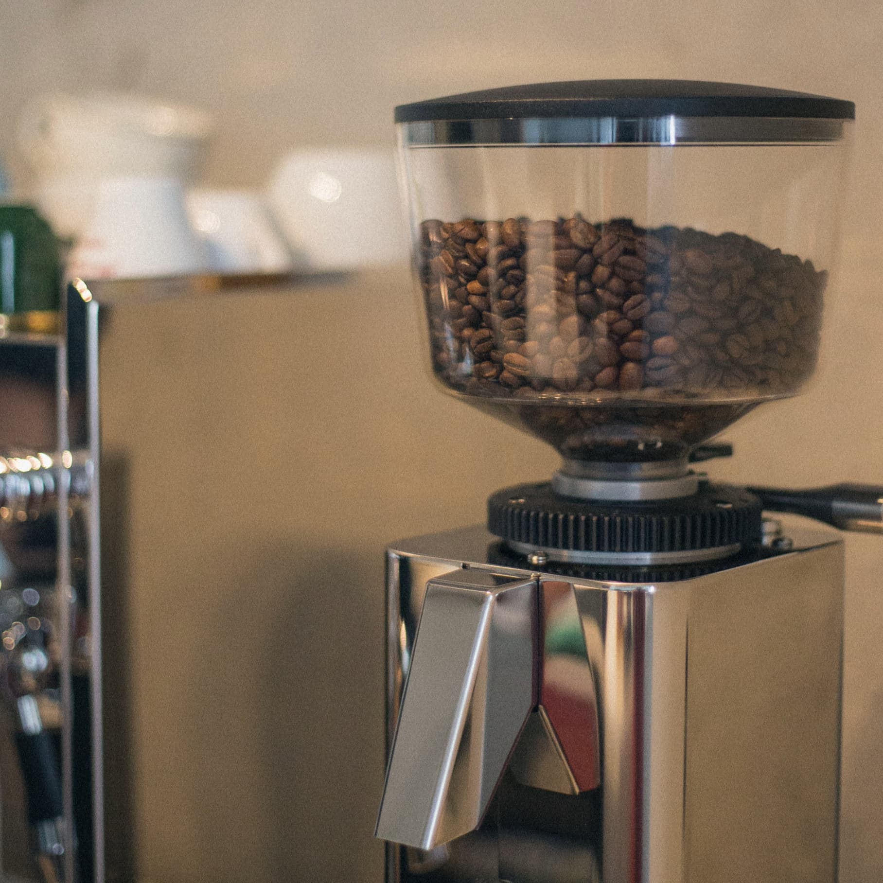 coffee grinder with hopper full of coffee beans