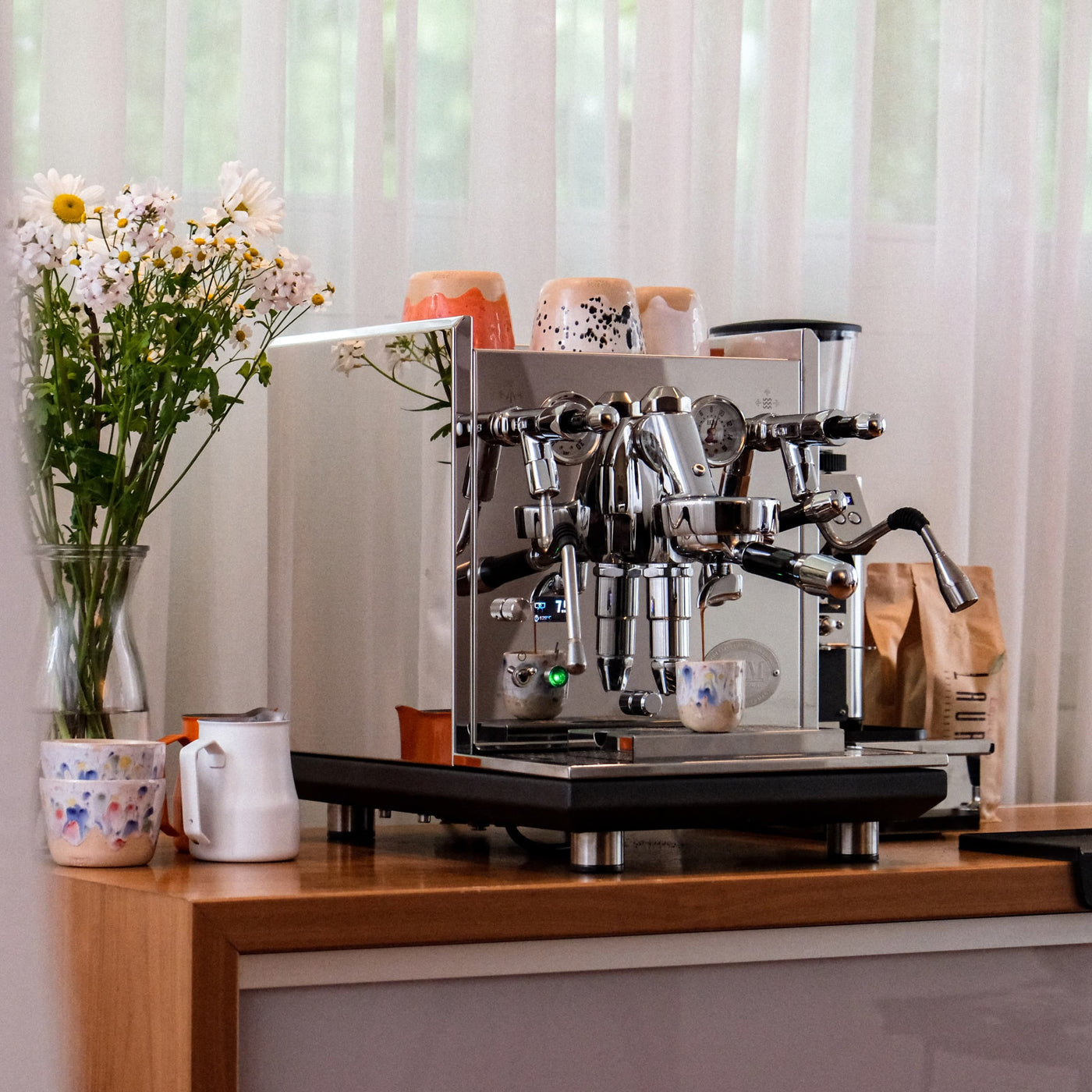 ECM sychronika ii barista setup in kitchen with flowers