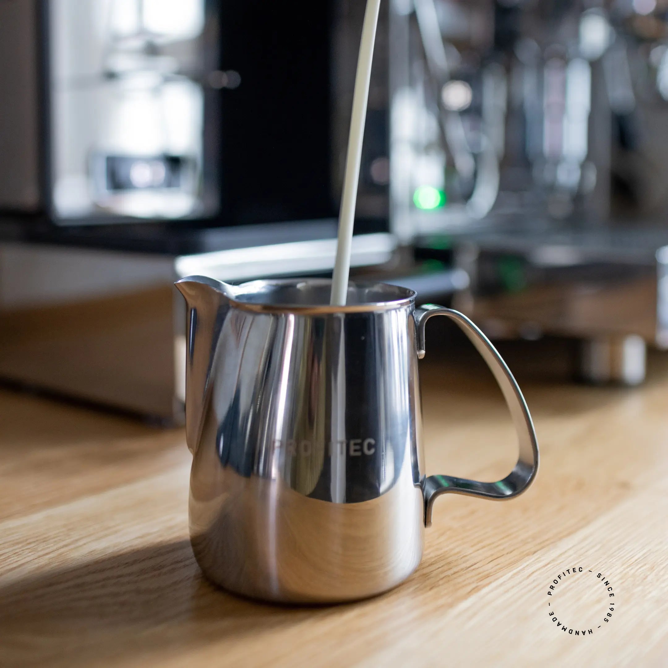 Pouring milk into profitec stainless steel milk pitcher