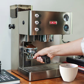 Lelit Kate PL82T espresso machine with someone using the built in grinder